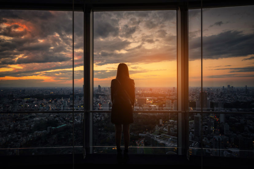 rear-view-traveler-woman-looking-tokyo-skyline-observation-deck-sunset