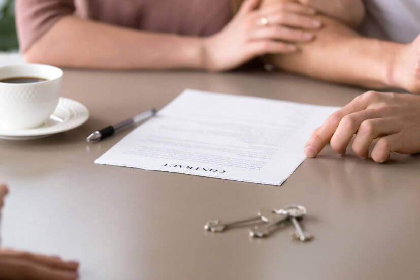 closeup-contract-table-couple-taking-mortgage-loan