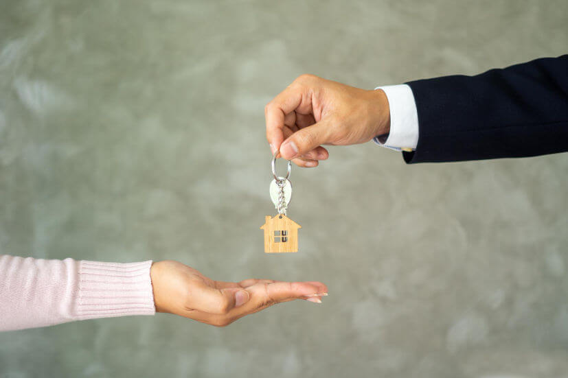 salesman-suit-was-sending-house-keys-new-landlord-buyer-receives-key-from-seller-concept-buying-selling-house