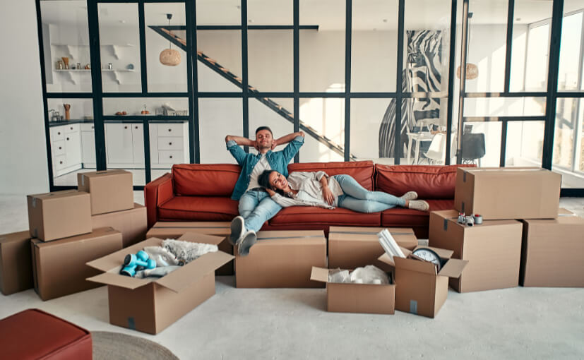 young-married-couple-sitting-sofa-living-room-home-happy-husband-wife-are-having-fun-are-looking-forward-new-home-moving-buying-house-apartment-concept